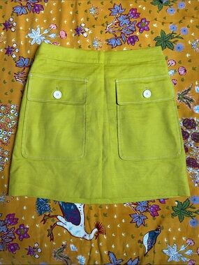 J. Crew lime green mini skirt with white buttoned pockets